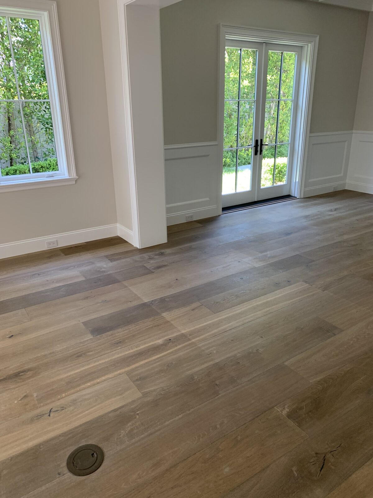 Wide-plank white oak floor in a room with French doors